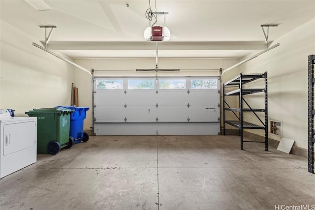 garage featuring a garage door opener and washer / dryer