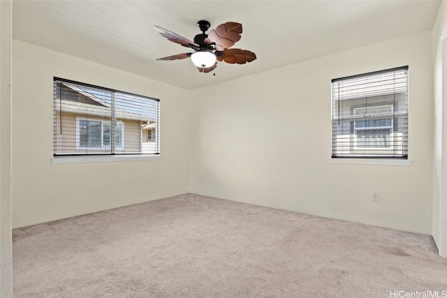 spare room with light carpet and ceiling fan