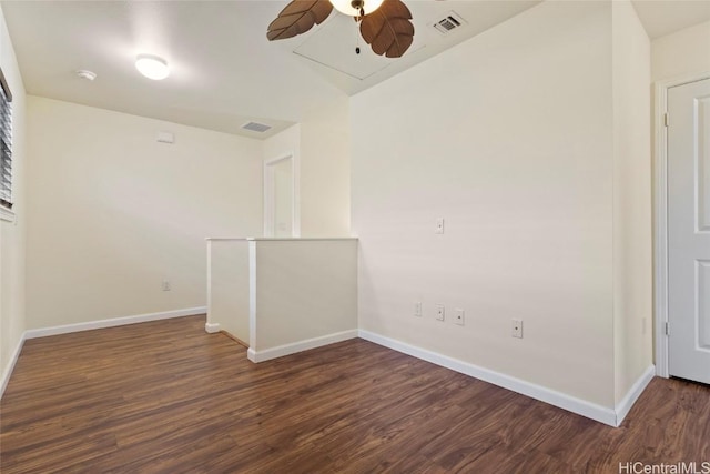 spare room featuring dark hardwood / wood-style flooring and ceiling fan