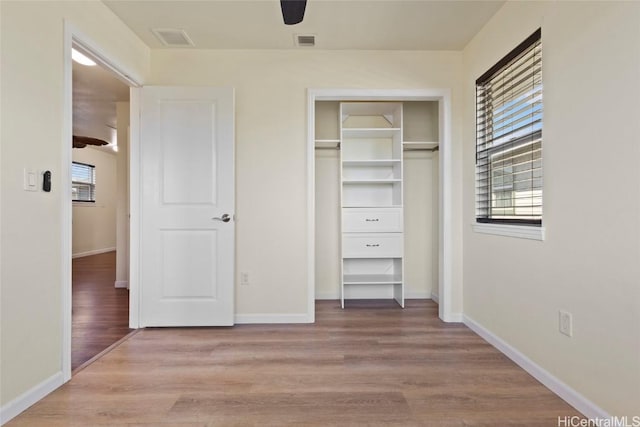 unfurnished bedroom with a closet, ceiling fan, and light wood-type flooring