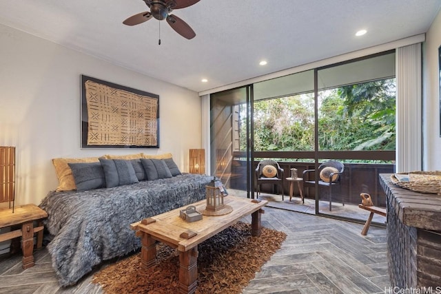 bedroom featuring expansive windows, parquet flooring, a textured ceiling, and ceiling fan