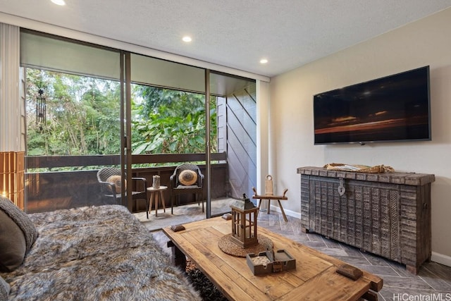 living room with expansive windows and a textured ceiling