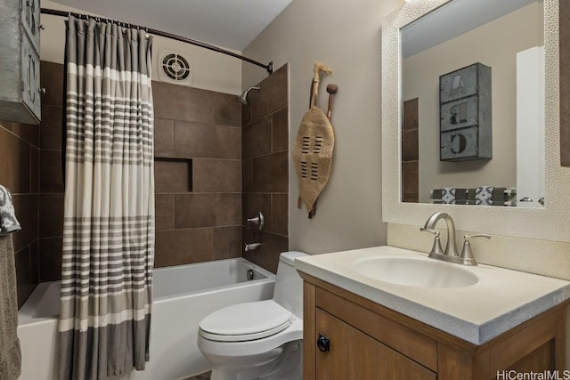 full bathroom with vanity, shower / tub combo, and toilet