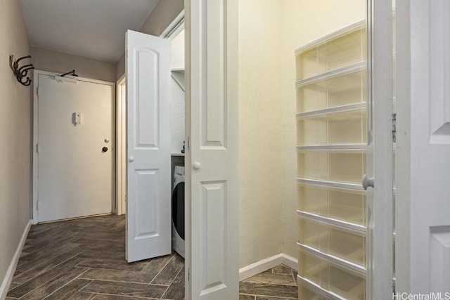 interior space with washer / clothes dryer and dark parquet flooring