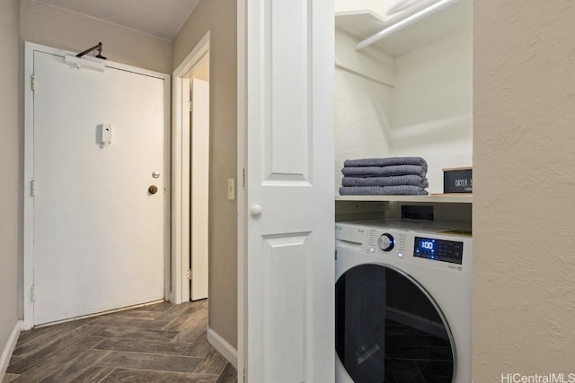 clothes washing area featuring dark parquet flooring and washer / dryer