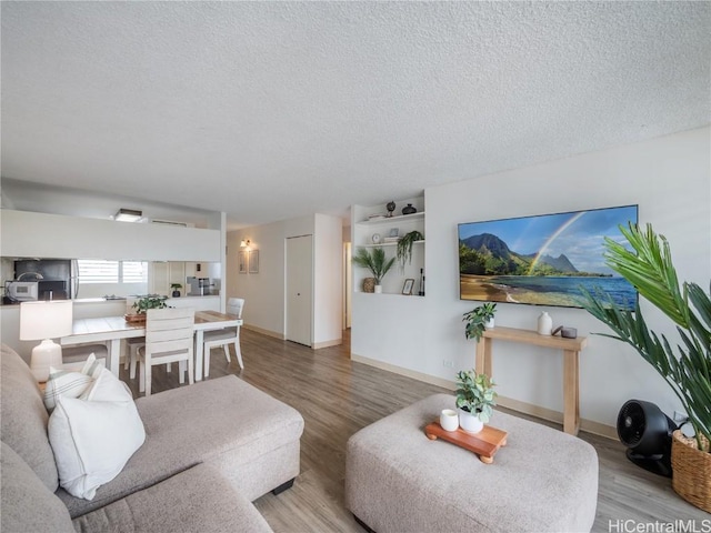 living room with hardwood / wood-style floors and a textured ceiling