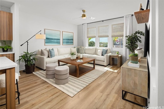 living room with light hardwood / wood-style floors and ceiling fan