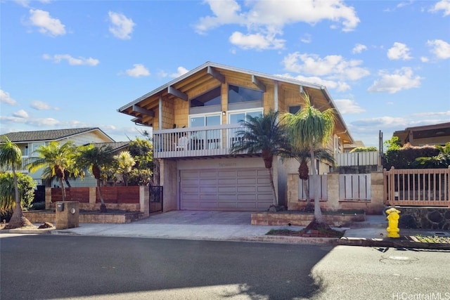 view of front of property featuring a balcony and a garage