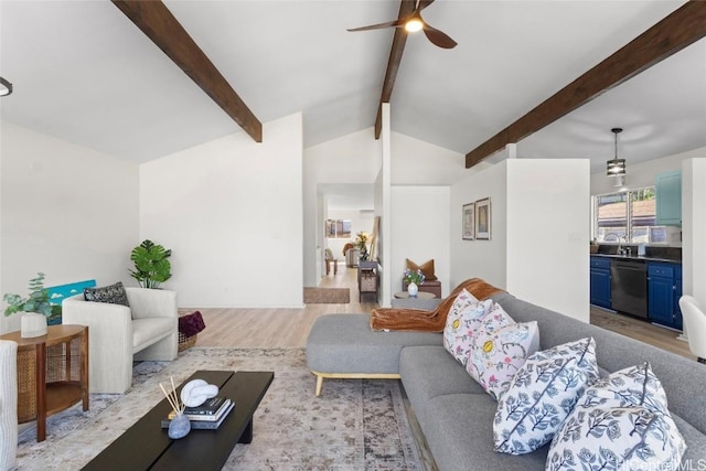 living room with lofted ceiling with beams, ceiling fan, sink, and light hardwood / wood-style floors