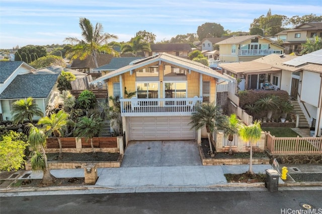 view of front of property featuring a garage and a balcony