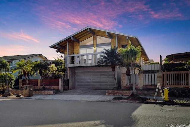 view of front of home with a balcony and a garage