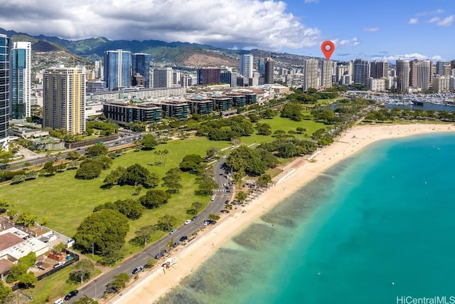 aerial view featuring a water and mountain view and a view of the beach