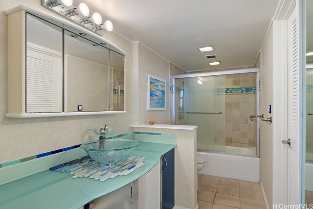 full bathroom with enclosed tub / shower combo, tile patterned flooring, vanity, ornamental molding, and toilet