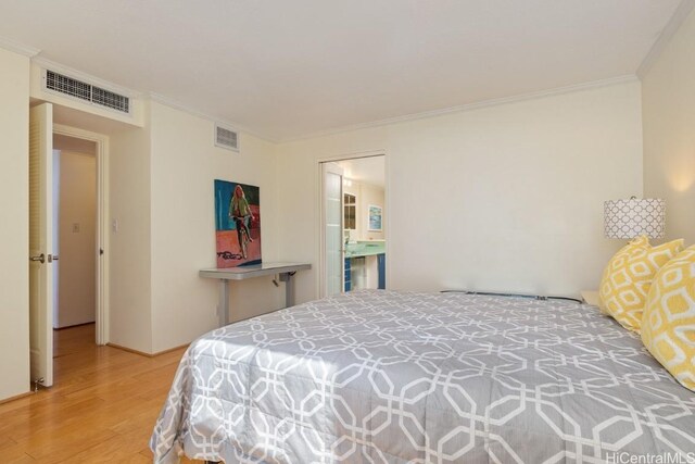 bedroom featuring ornamental molding and hardwood / wood-style floors