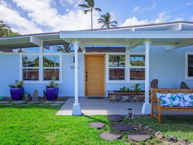 doorway to property featuring a yard