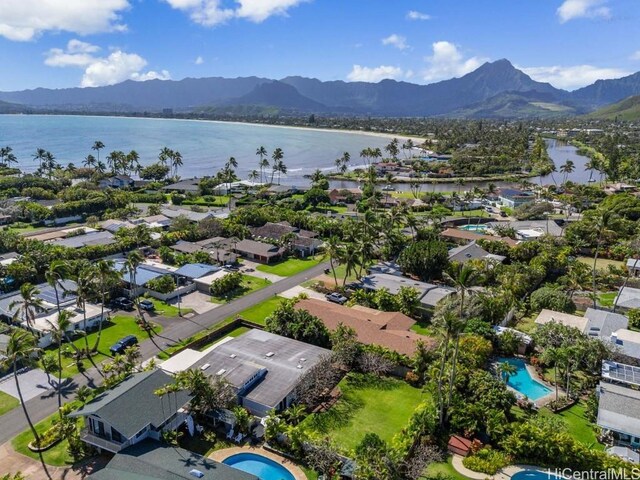 birds eye view of property with a water and mountain view