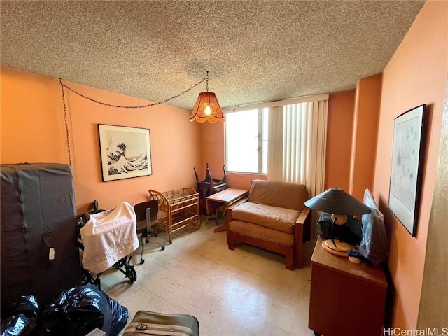 living area featuring a textured ceiling