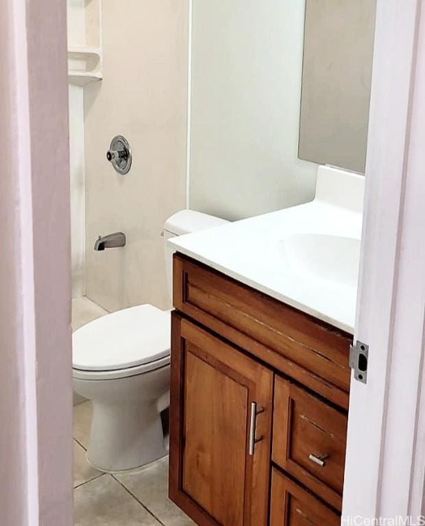 bathroom with tile patterned flooring, a shower, vanity, and toilet