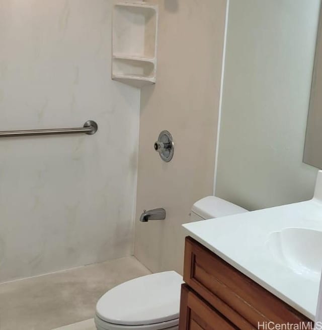 bathroom with walk in shower, vanity, and toilet