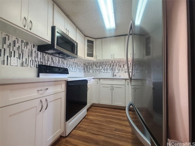 kitchen featuring dark wood-style floors, white cabinets, stainless steel appliances, and light countertops