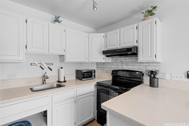 kitchen with black range with electric stovetop, sink, and white cabinets