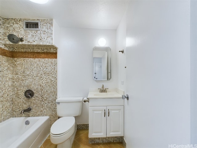 full bathroom featuring tiled shower / bath, vanity, toilet, tile patterned floors, and a textured ceiling