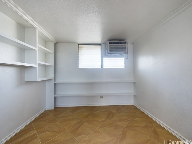 unfurnished room with a wall mounted AC and a textured ceiling