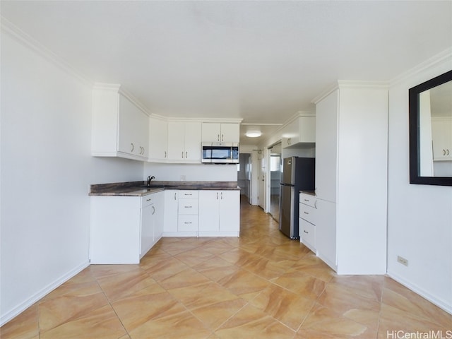 kitchen with sink, stainless steel appliances, and white cabinets