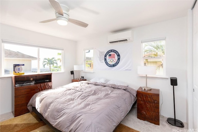 bedroom with ceiling fan, light colored carpet, and an AC wall unit