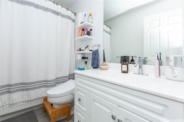 bathroom featuring vanity, curtained shower, and toilet