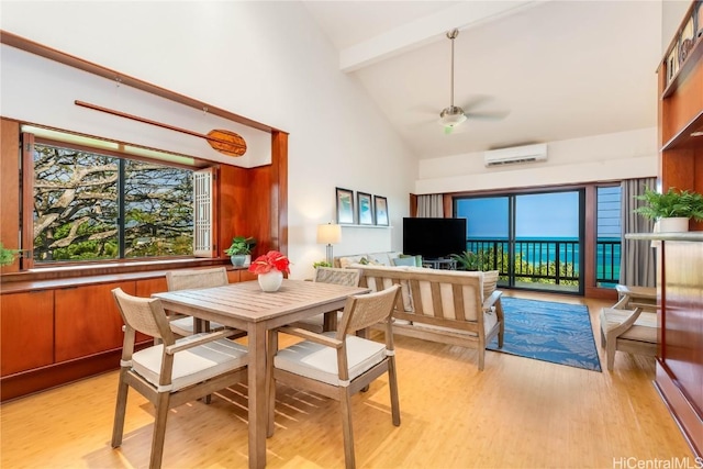 dining space featuring an AC wall unit, light wood-type flooring, plenty of natural light, and beamed ceiling