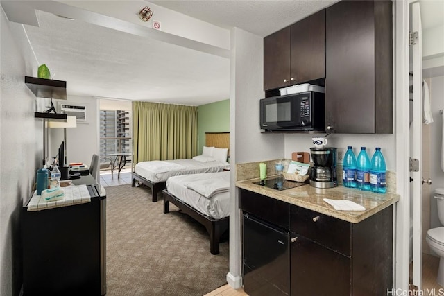 bedroom featuring a wall mounted air conditioner and light carpet