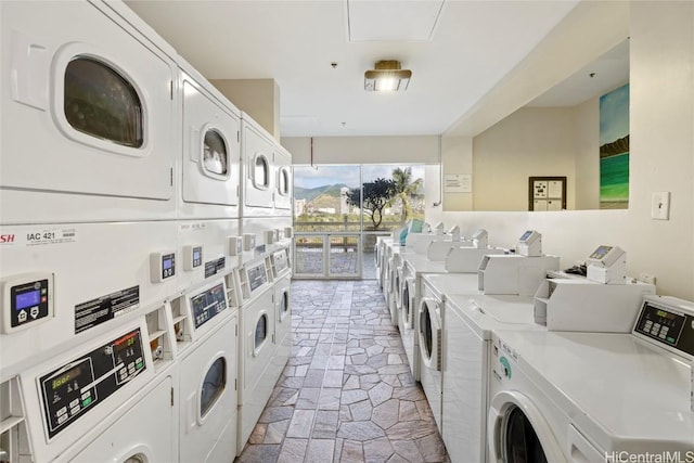 laundry room featuring stacked washer and dryer and independent washer and dryer