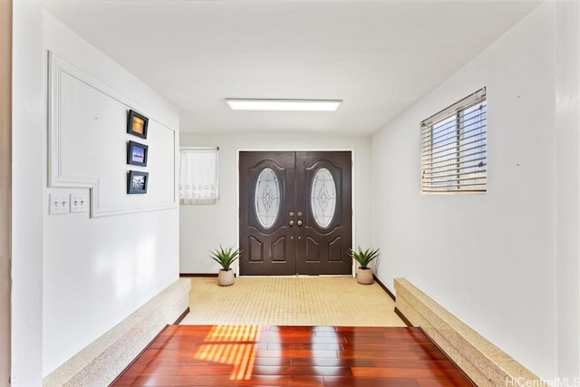 carpeted entryway featuring french doors