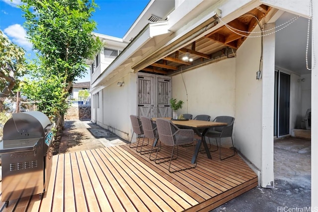 wooden deck featuring area for grilling