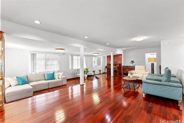 living room with hardwood / wood-style flooring and decorative columns