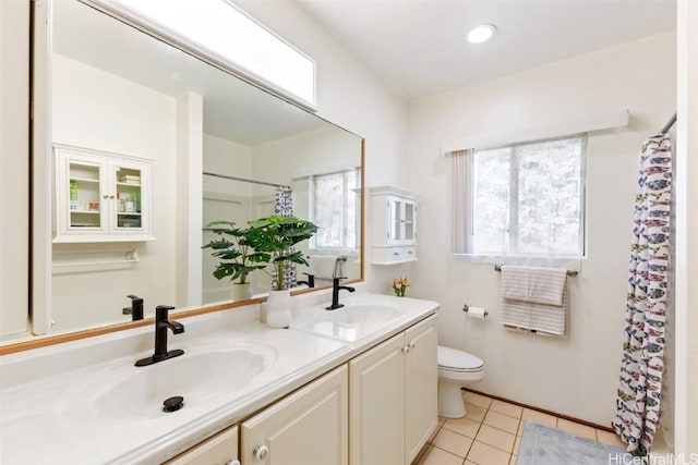 bathroom featuring vanity, toilet, and tile patterned flooring