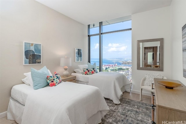 bedroom featuring hardwood / wood-style floors and floor to ceiling windows