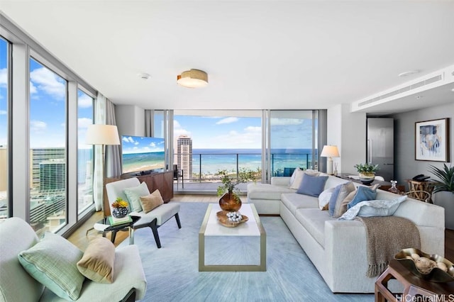 living room featuring floor to ceiling windows, light hardwood / wood-style floors, and a wealth of natural light