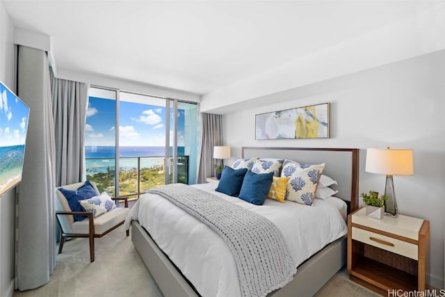 carpeted bedroom featuring a water view, floor to ceiling windows, and access to exterior