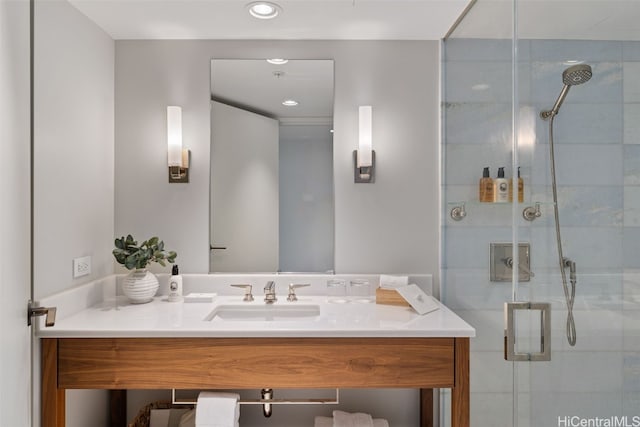 bathroom featuring walk in shower and vanity