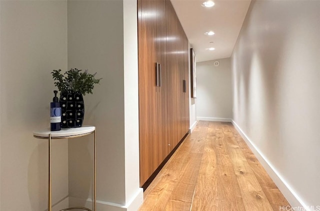 corridor with light wood-type flooring