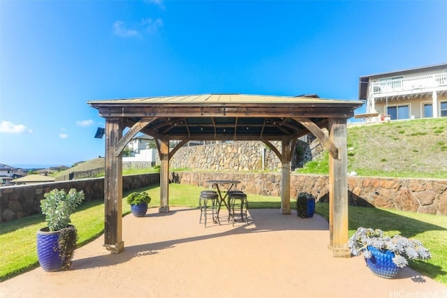 view of property's community with a yard, a gazebo, and a patio area