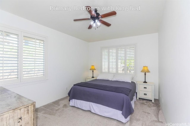 carpeted bedroom featuring multiple windows and ceiling fan