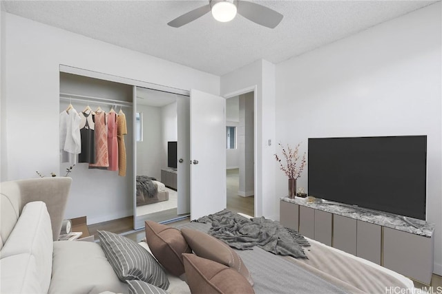 bedroom featuring ceiling fan, a closet, and a textured ceiling