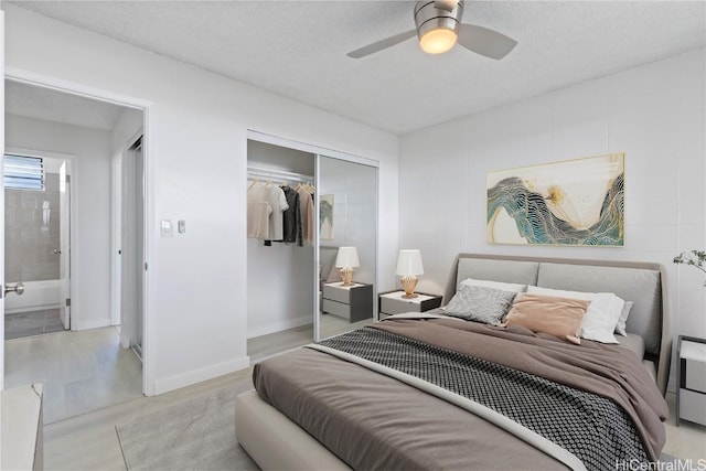 bedroom featuring a textured ceiling, ceiling fan, and a closet