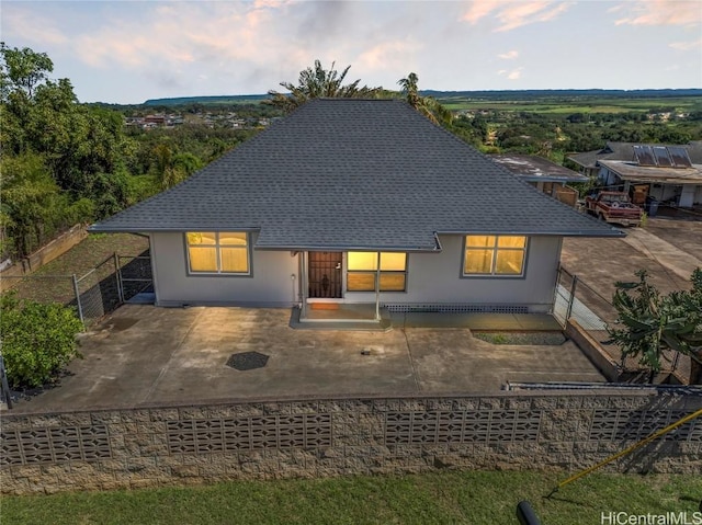 back of property featuring a shingled roof