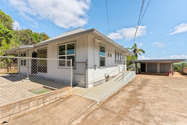 view of front of home with concrete driveway and fence