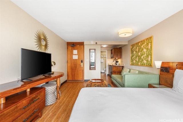 bedroom featuring sink and light hardwood / wood-style floors