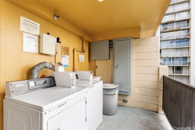 clothes washing area with washer and clothes dryer